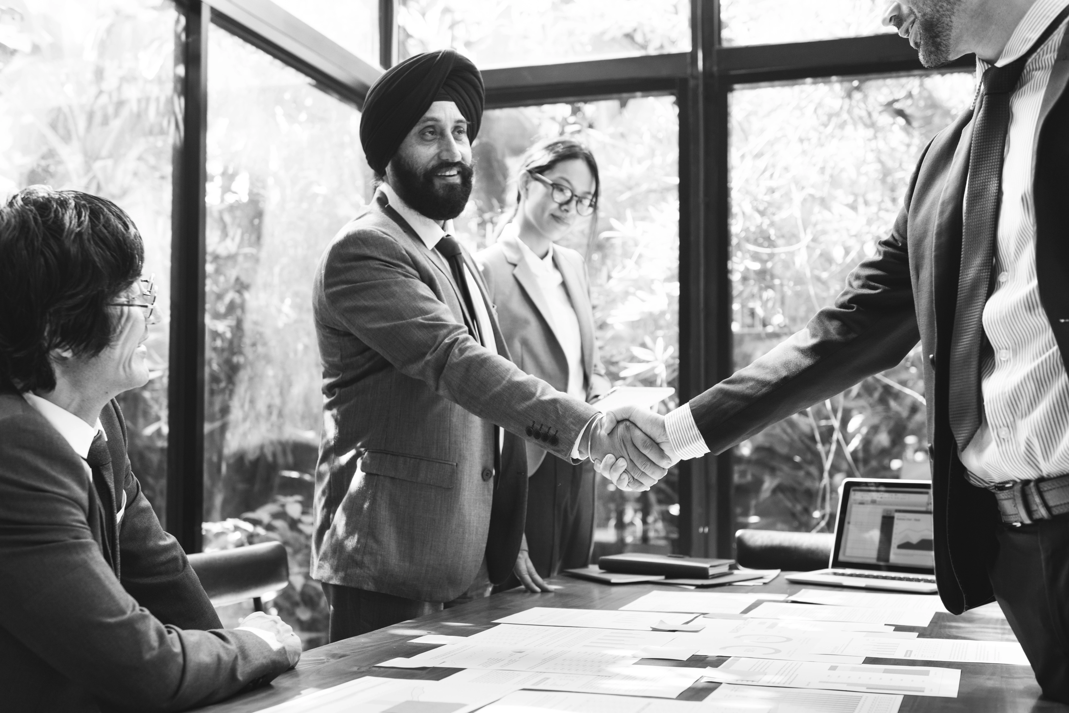 Industry representatives shaking hands at a partner meeting